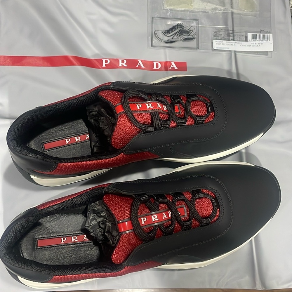 Brand new, never worn black/red rubber sneaker. Box and Prada shoe sack included